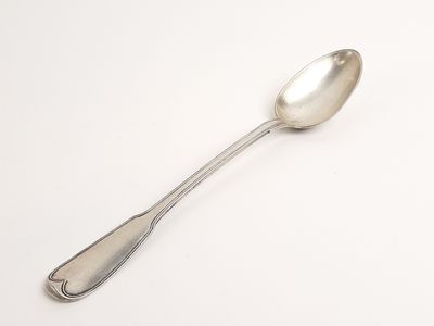 silver spoon on a white surface with a white background
