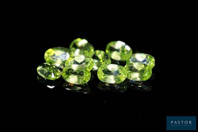 a group of green gems on a black surface