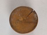 a small copper plate with a crack in the middle