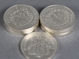 three silver coins sitting on top of each other on a table