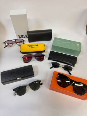 Plusieurs paires de lunettes de soleil, des lunettes de soleil et un étui sont disposés sur une table