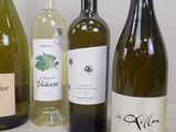 several bottles of wine are lined up on a table