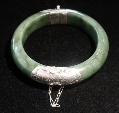un bracelet vert auquel est attachée une chaîne