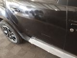 a car that has been painted black and has a denting on the side