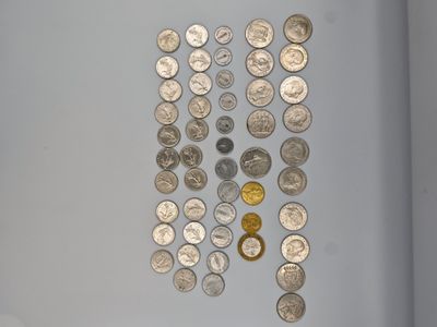 a lot of coins that are on the table