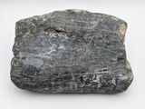 a close up of a rock on a white surface
