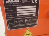 an orange machine with a sign on the side of it that says jig