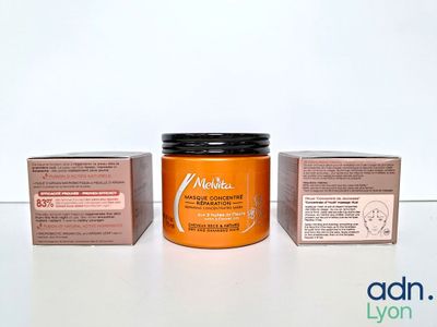 a jar of cream sitting next to a box of soap