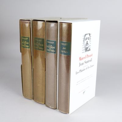 three books are stacked on top of each other on a white surface