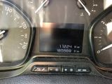 a close up of a car dashboard with a clock on it