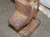 a rusted toilet sitting in the corner of a room