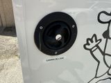 a sticker on the side of a white box with a sticker of a cartoon character on it