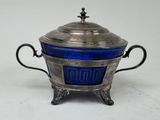 an antique silver and blue glass covered bowl with handles