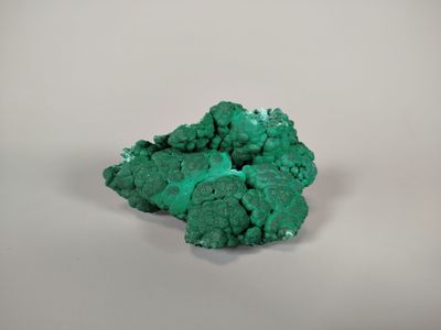 green mineral on a white surface with a white background