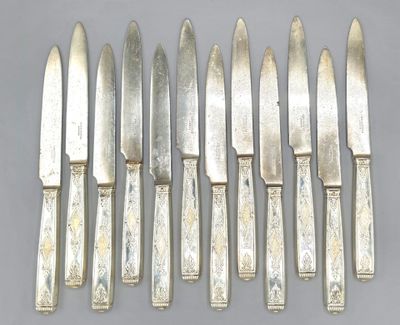 six knives are lined up in a row on a gray surface
