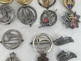 some of the badges are laying out on a white surface