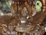 a glass vase with a crystal ball on top of it