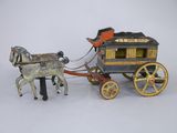 a toy horse pulling a carriage with a man on it