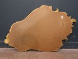 an image of a wooden mirror sitting on top of a carpeted floor