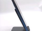 a cell phone sitting on a stand on a white surface