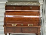 a wooden desk with a marble top and drawers