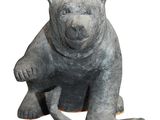 a statue of a bear that is sitting on its hind legs