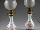 pair of antique glass lamps with floral designs on them on a gray background