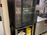 a large stainless steel oven in a commercial kitchen