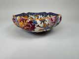a close up of a bowl on a table with a white background