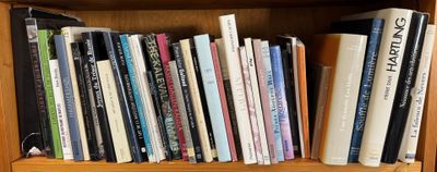 a book shelf with many books on it in a room