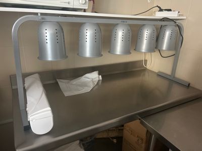a metal counter with a bunch of buckets on top of it