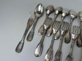 a lot of silver spoons and forks on the table