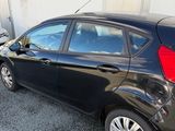 a black car that is parked in front of a building