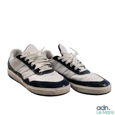 a pair of white and blue sneakers on a white background