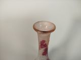 a glass vase with a flower design on it