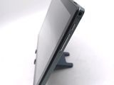 a tablet computer sitting on a stand on a white surface