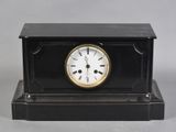 an image of a black and gold clock sitting on top of a table