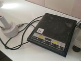 a laptop computer sitting on a counter next to a lamp