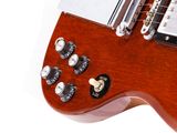 a close up of a guitar that is on a white surface