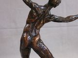 statue of a man holding a tennis racquet on a marble base