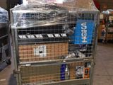 a metal cart with many boxes on it in a warehouse