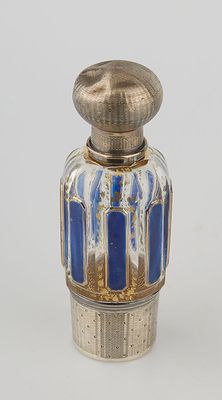 an image of a silver and blue glass perfume bottle on a white surface