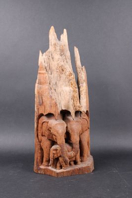 an elephant and calf carved into a piece of wood on a gray background