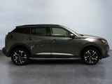 a grey nissan suv parked in a room with a white wall