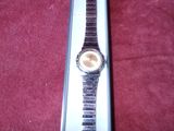 a watch that is sitting in a box on a red carpet