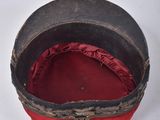 a red hat that is sitting on a white surface