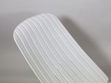 a white chair that is sitting on a white table