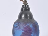 a blue and purple vase on a white surface
