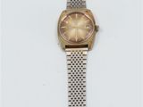 a close up of a wrist watch on a white surface