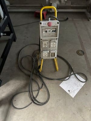 a machine that is sitting on the ground next to a bunch of wires